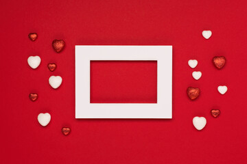 Red white hearts and empty frame on red background. Valentines day concept.