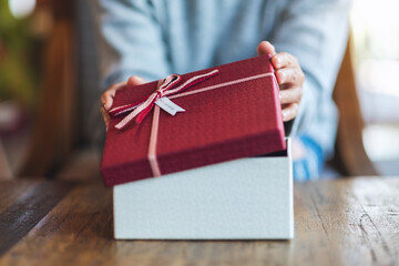 Closeup image of a woman opening a gift box