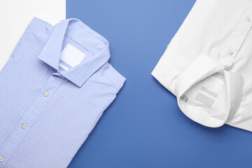 New male shirts on color background