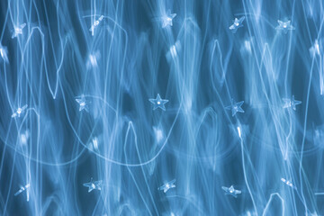 Blue abstract background texture with light trails and stars. Christmas celebrate design. New year background.