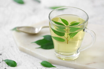 Cup of green tea on table