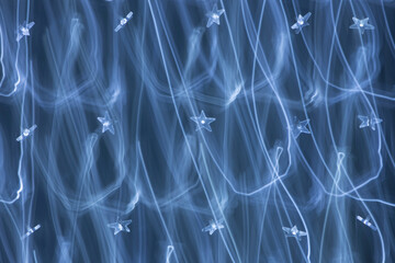 Blue abstract background texture with light trails and stars. Christmas celebrate design. New year background.