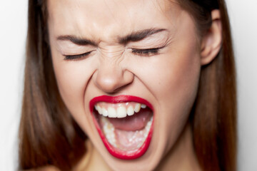 woman with wide open mouth and closed eyes face closeup