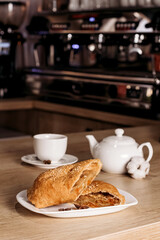 Apple strudel with coffee in a cafe. European cuisine.