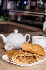 Apple strudel with coffee in a cafe. European cuisine.
