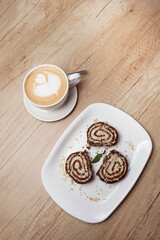 Serpentine cookies and coffee. Vertical photo.