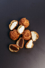 Profiteroles with different flavors. French dessert.