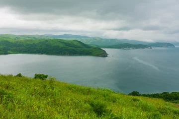 Fototapeten Bay of the sea from the top of the hill of the mountainous coast, summer landscape and seascape in cloudy cloudy weather. © Evgeniy