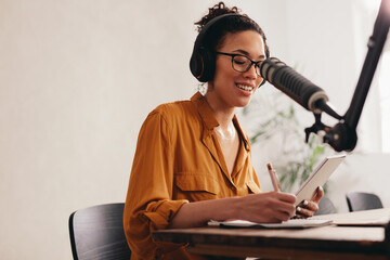 Young woman recording podcast from home
