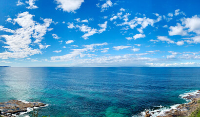Full HD wallpaper background crystal clear sea, blue sky with white cloud beautiful seascape panorama. Rock composition of nature coast view.