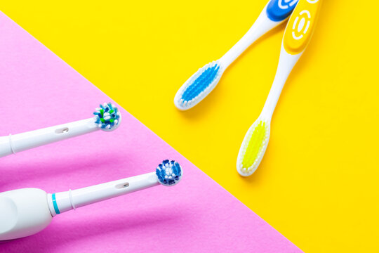 Two Professional Electric Toothbrushes Against Manual Brushes on Pink and Yellow Backgrounds.