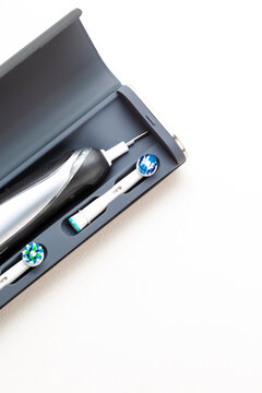 Electric Toothbrush With Spare Attachments in Travel Case on White Background.