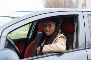 Serious girl in a car, African American