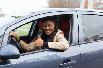 Fototapeta na wymiar Happy girl in a car driving, African American