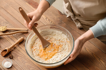 Woman preparing pumpkin pie on table