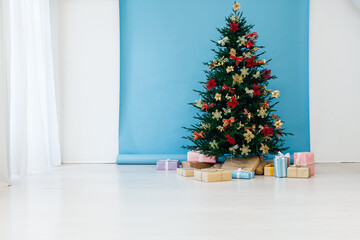 New year decorated Christmas tree with gifts in the room