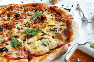 freshly baked pizza on a white tablecloth