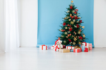 New year decorated Christmas tree with gifts in the room