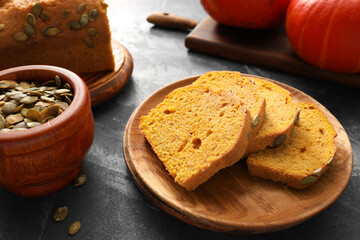 Plate with tasty pumpkin pie on dark background