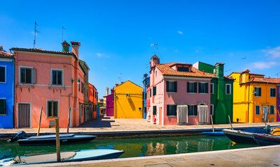 Fototapeta na wymiar Burano island canal, colorful houses and boats in the Venice lagoon. Italy