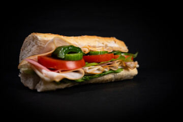 Delicious fresh sandwich with chicken, cheese and vegetables.