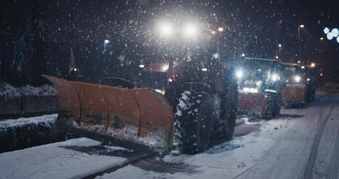 Tractor snow plow machines parked mid winter pandemic night curfew