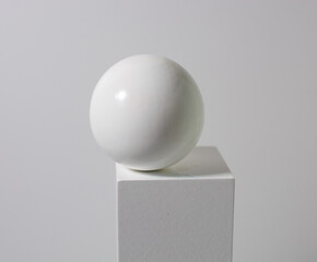 white ball on a white cube, on a white background. beauty minimalism concept, drawing lessons.