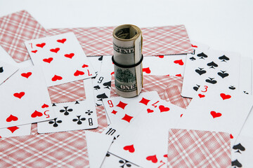 Fototapeta na wymiar Dolarras on the background of playing cards. Gambling