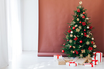 New year decorated Christmas tree with gifts in the house