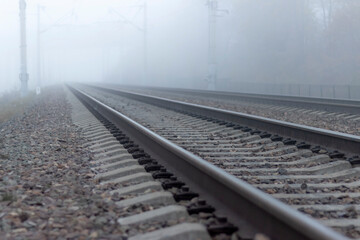 Railroad tracks stretching into the misty distance. The path into fog and uncertainty.