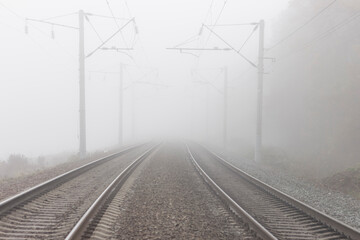 Railroad tracks stretching into the misty distance. The path into fog and uncertainty.
