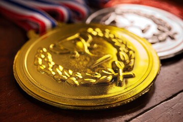 Close up part of gold medal on the table , win concept.