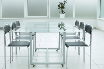 Black chairs glass table in office space