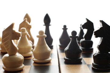 Wood chess pieces on a board