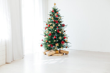 Christmas tree with new year gifts in the white room
