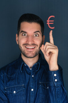 Mann zeigt mit Zeigefinger auf ein Euro Zeichen Geld