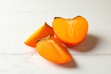 Fresh ripe persimmon on wooden background, close up
