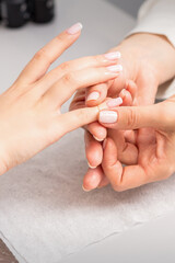 Obraz na płótnie Canvas A woman's hand getting a finger massage in a nail salon. Manicure treatment at beauty spa