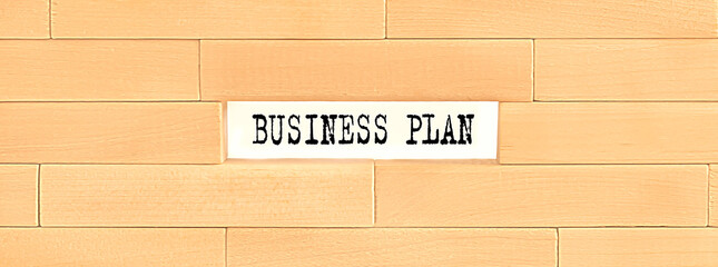 BUSINESS PLAN text on the wooden block wall, business