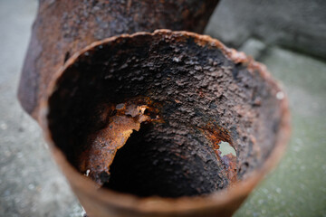 Shallow depth of field (selective focus) image with a very rusty metal pipe.