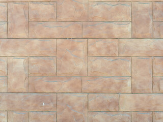 Fototapeta premium Beige wall with embossed rectangular tiles lined with pattern. Background texture
