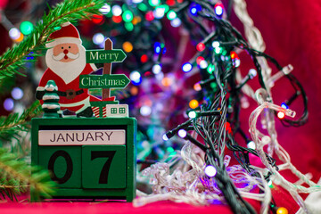 christmas calendar with santa claus on a background of lights and fir branches