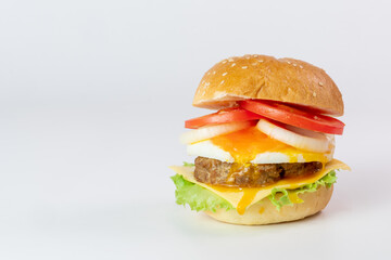 Burger, hamburger, cheeseburger, in bun with lettuce, tomato, onion, fried egg, delicious fast food, on white background.