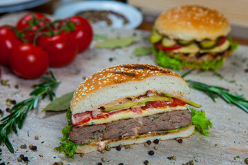 Fresh and juicy hamburger. Delicious cheese burger on a rustic wooden table