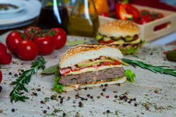 Fresh and juicy hamburger. Delicious cheese burger on a rustic wooden table