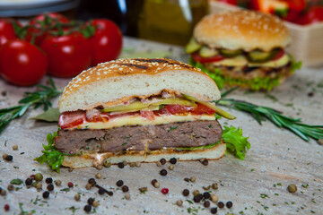 Fresh and juicy hamburger. Delicious cheese burger on a rustic wooden table