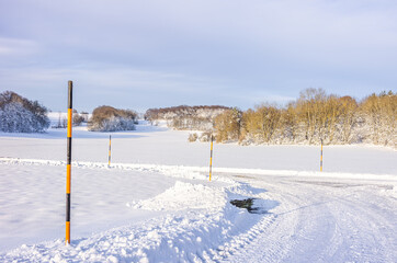 Snow poles at the edge of a country lane - Snow poles at the edge of a country lane in a winter...