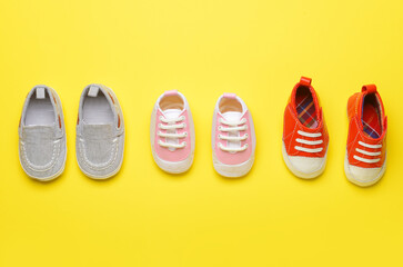 Baby shoes on color background