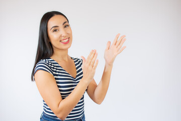 Young brunette woman applauding after presentation in a conference over isolated background