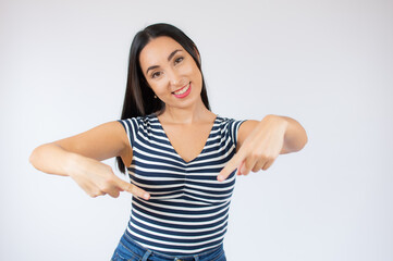 Smiling happy woman in striped t-shirt pointing at the camera with both hands over white background